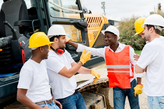 Group of workers talking at a building site.jpeg